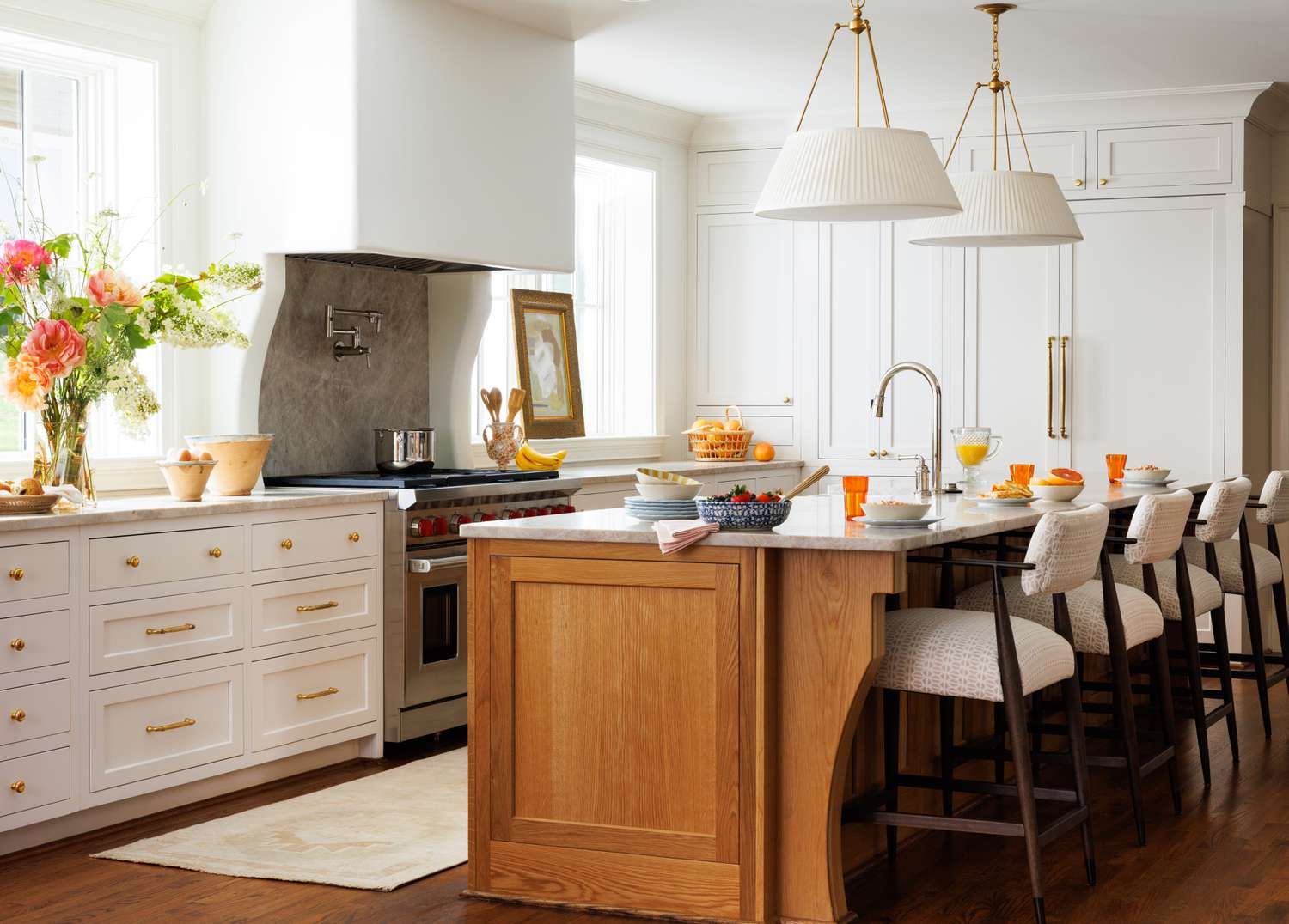 a white kitchen with brass hardware