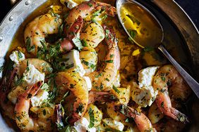 close up of shrimp and herbs with spoon
