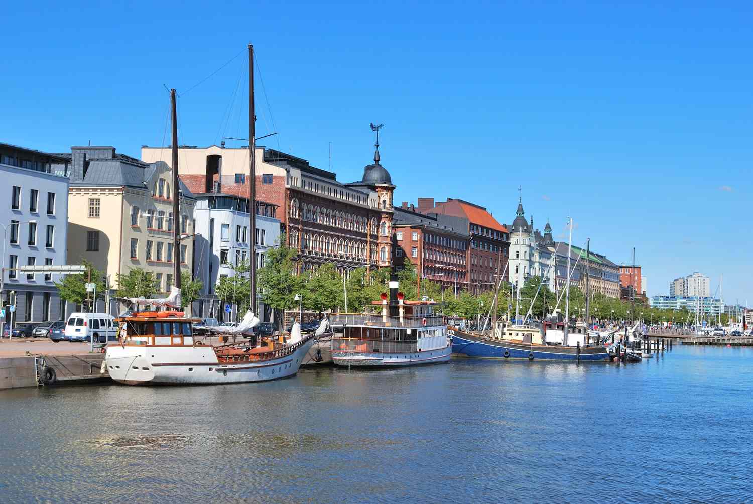 A waterfront area with docked boats and historic buildings along the shore
