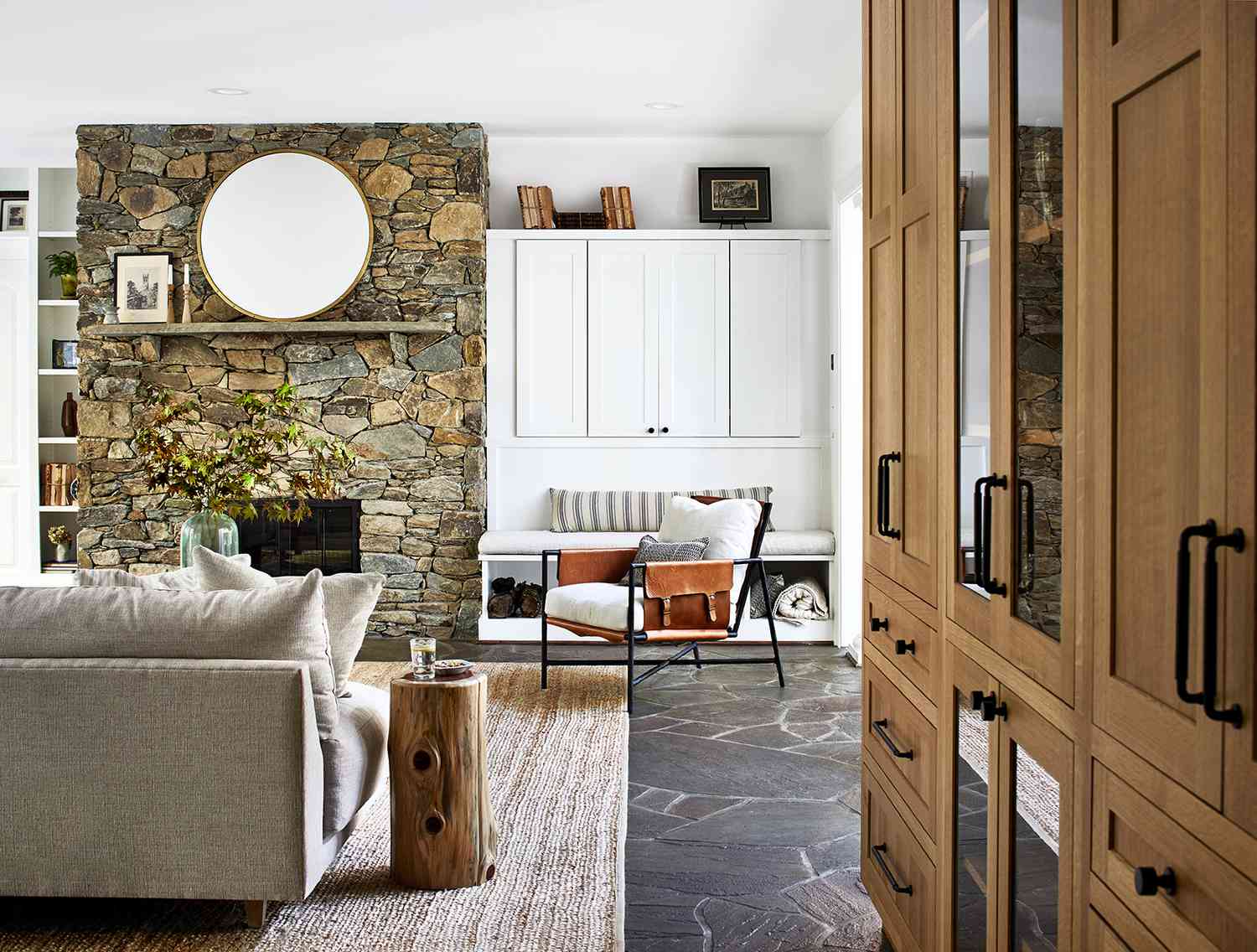 rustic modern living room with neutral tones and stone fireplace