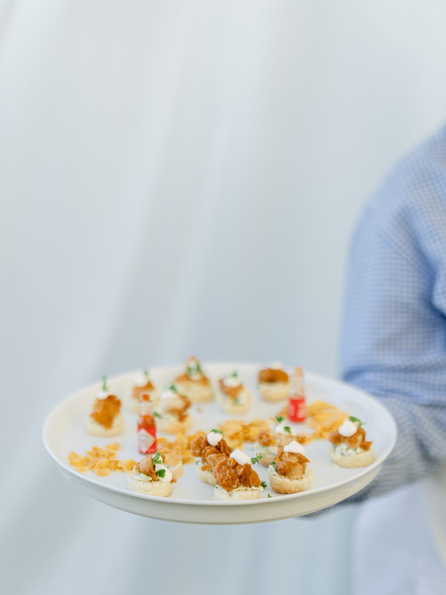 Southern themed wedding finger food of biscuits and fried chicken