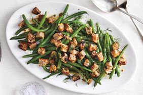 Plate of green beans topped with croutons