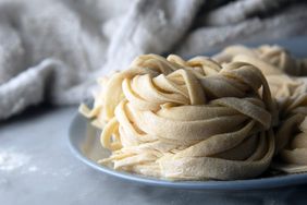 Bundles of uncooked pasta resting on a plate