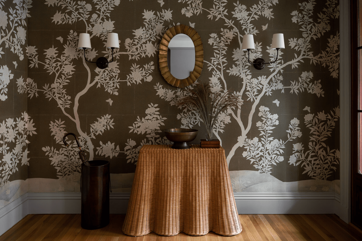 green wallpaper with rattan console in hallway