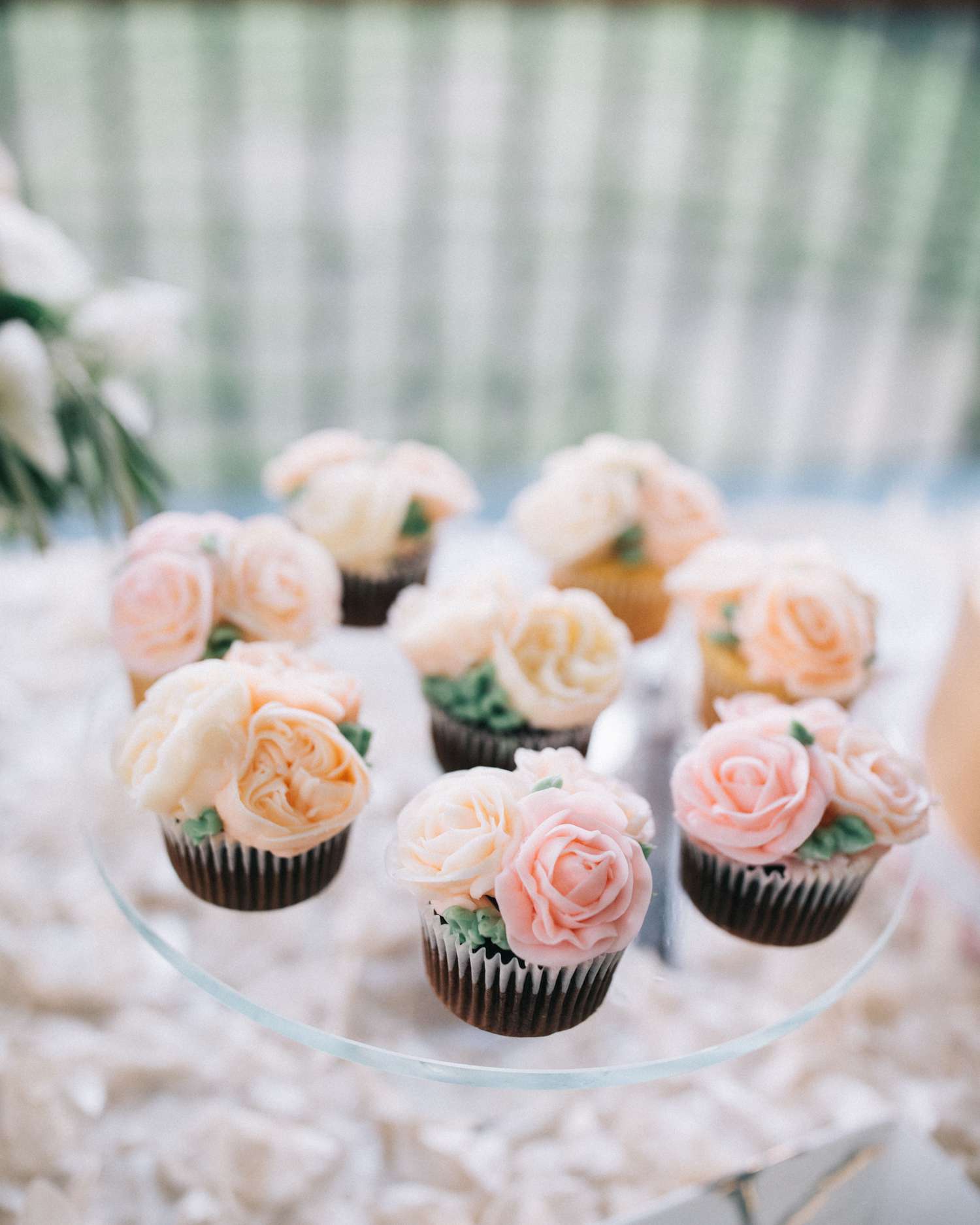 mini chocolate cupcakes with peach and pink frosted flowers