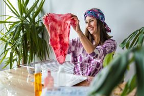 woman making tie-dye baby clothes