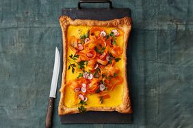 A rectangular vegetable tart with a knife placed beside it