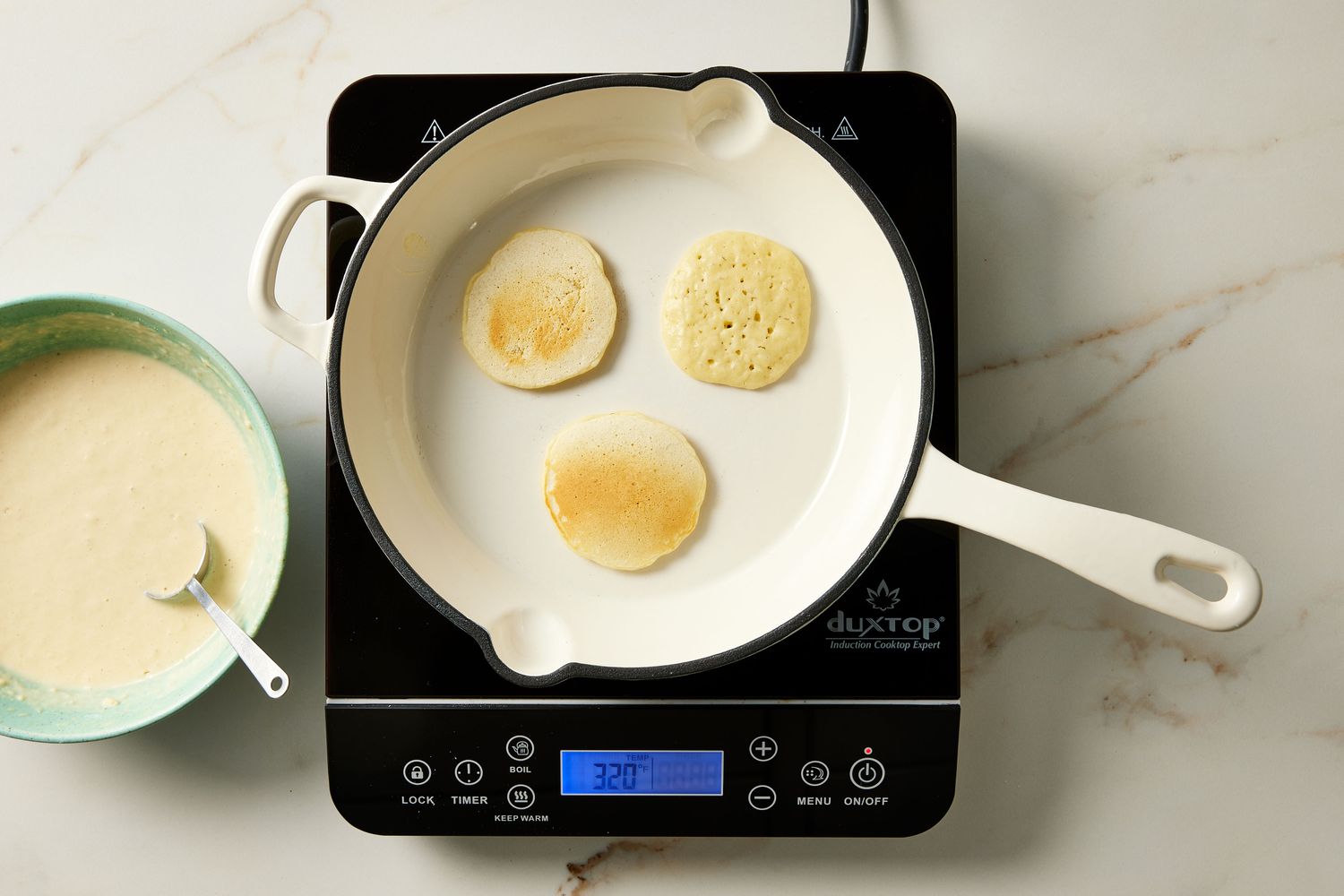 Silver dollar pancakes in pan flipped over