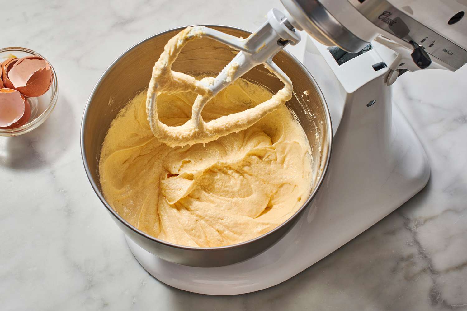 yellow cake batter in mixer bowl after eggs added