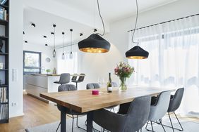 white dining room with pendant lights