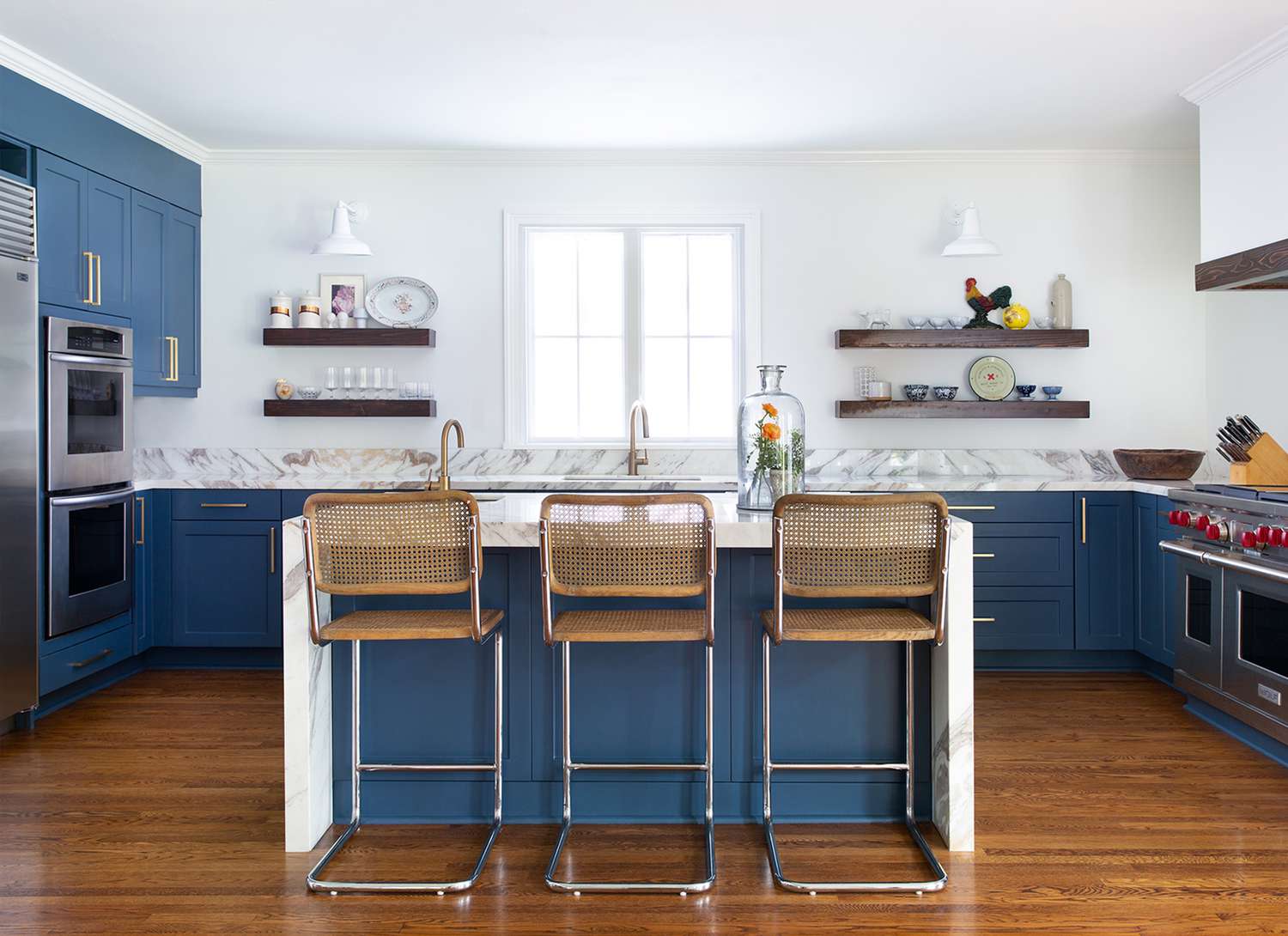 modern blue kitchen with island and open shelving