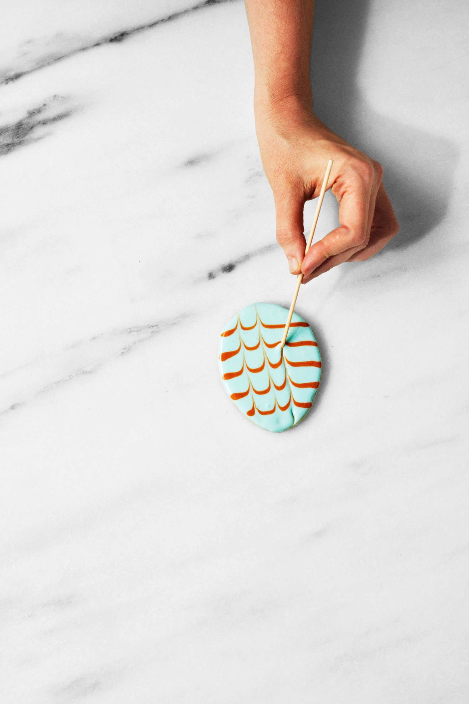 martha using toothpick to draw chevron pattern on cookies