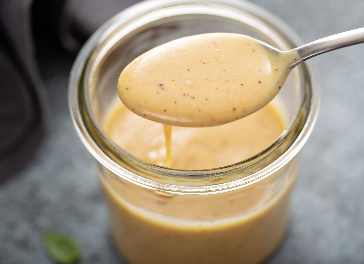 close up of honey mustard dressing in a jar