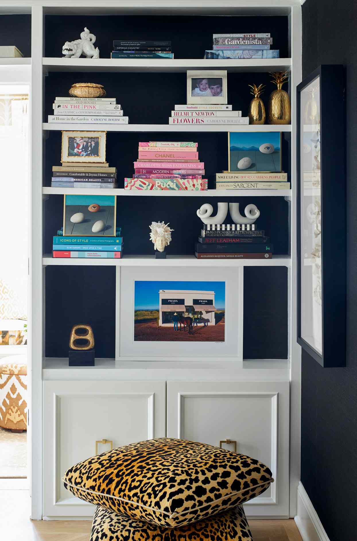 white wall built in bookshelf with dark blue background