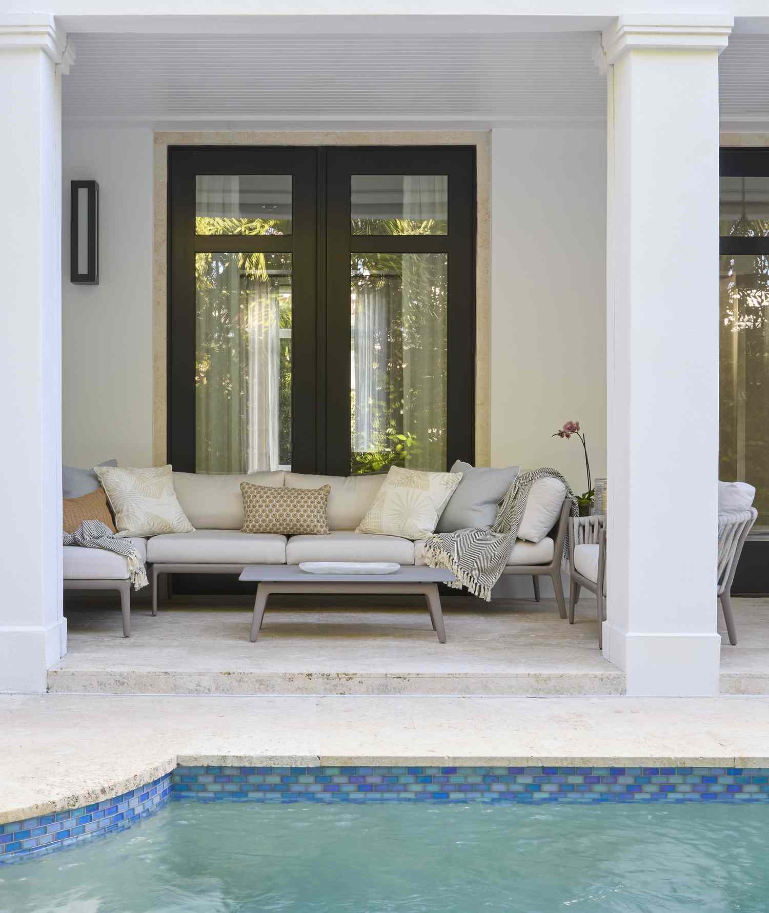 covered porch with layered blankets and pillows