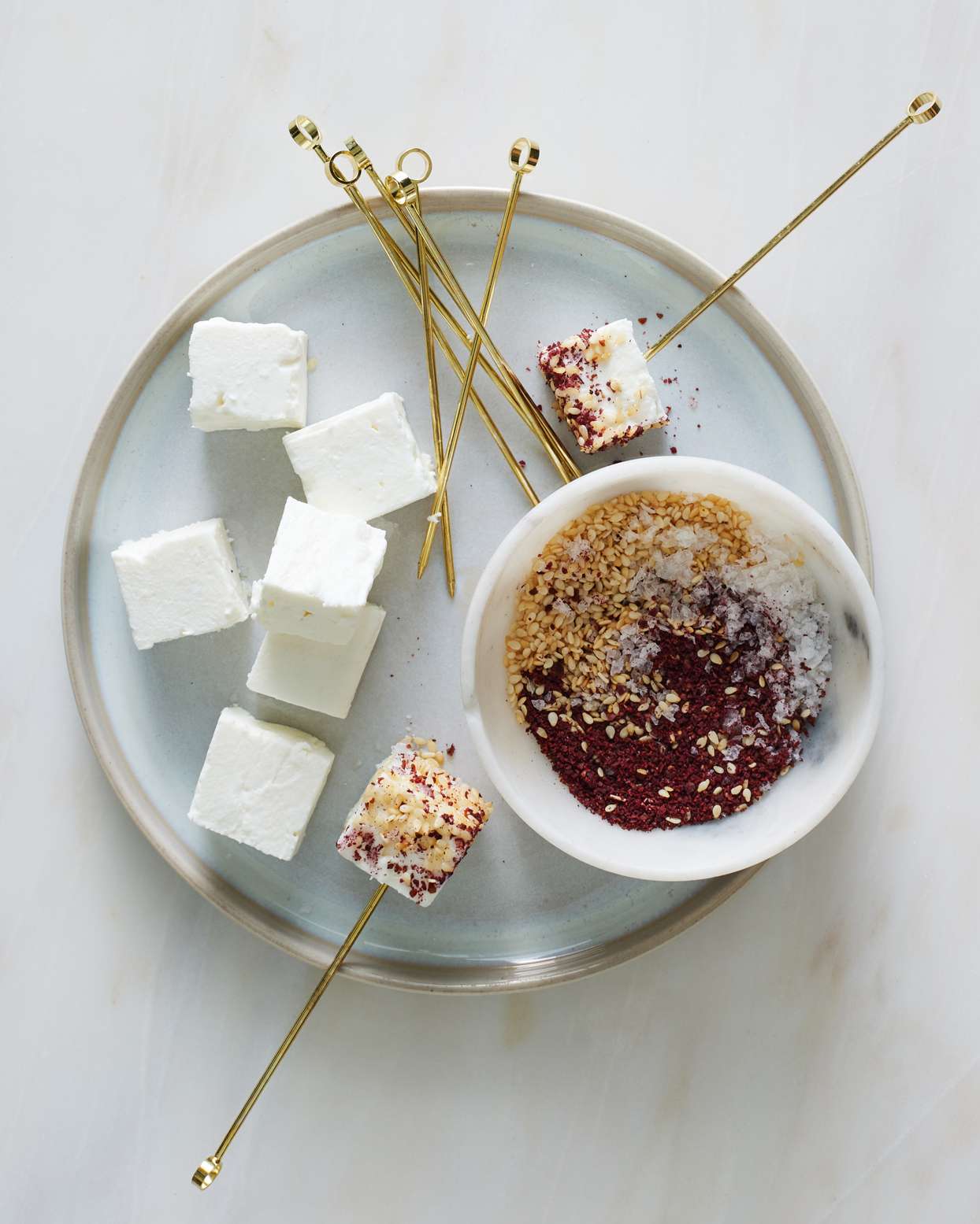 seeded feta bites served with gold skewers