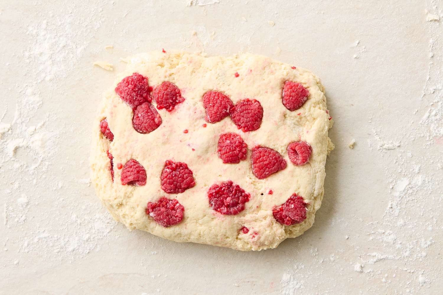 Dough preparation with embedded raspberries ready for shaping or cutting