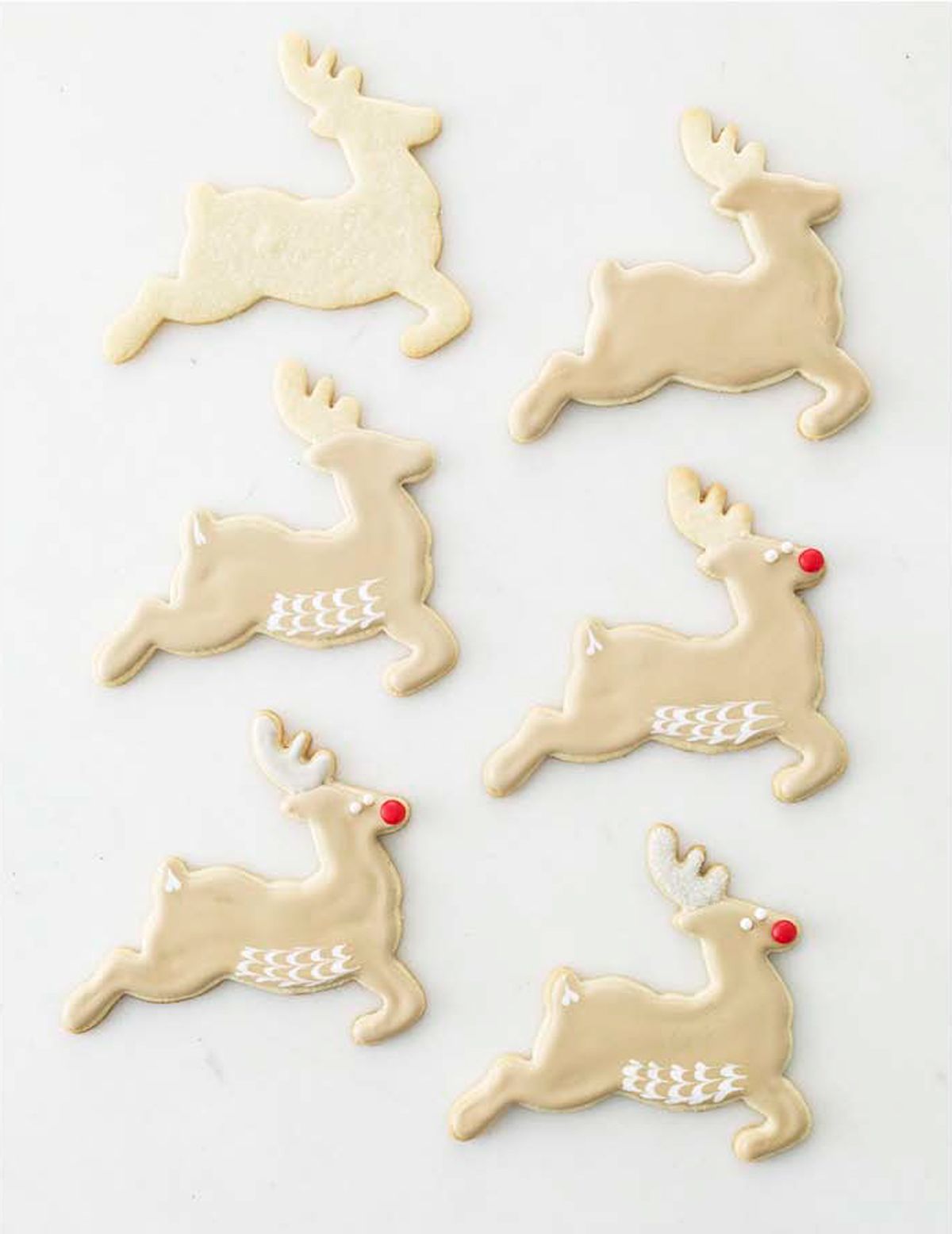 Six reindeershaped cookies decorated with icing arranged in two columns of three