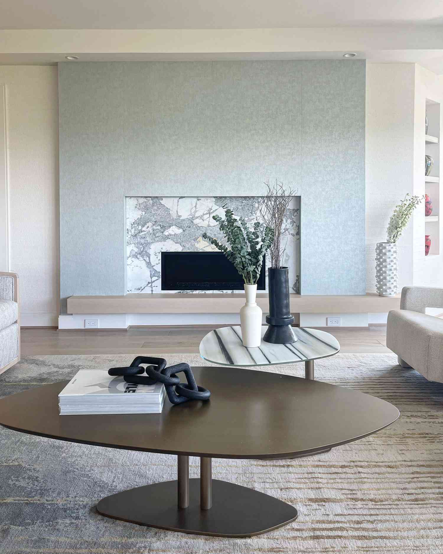 light blue accent wall with marble fireplace