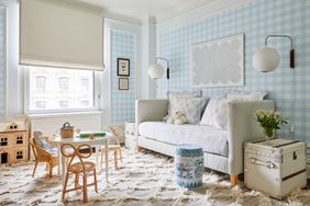 Kid's room with blue gingham wallpaper and light furniture