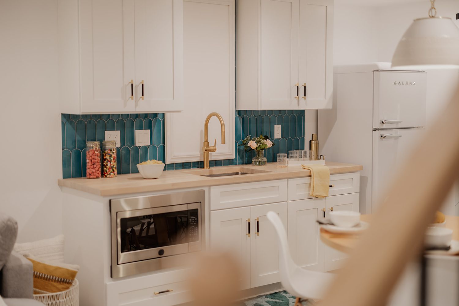 whiet kitchen with leather wrapped cabinet hardware