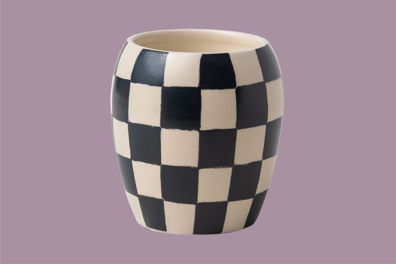 black and white checkered candle on purple background