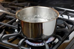 water boiling in a stainless steel pot on gas stove