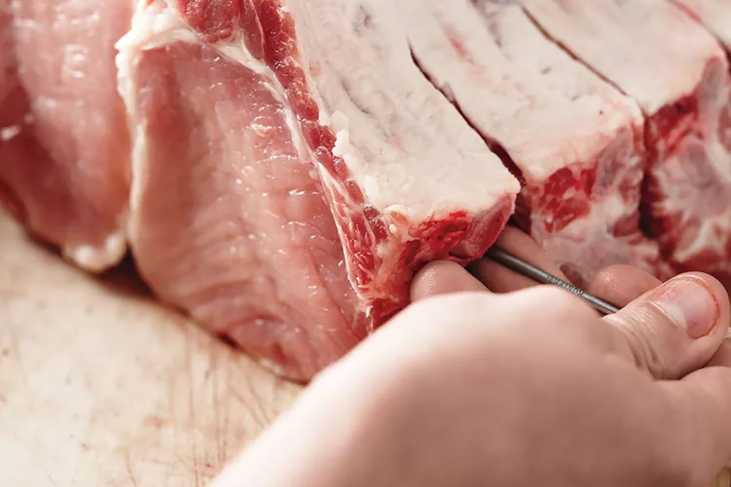 someone threading a pork roast