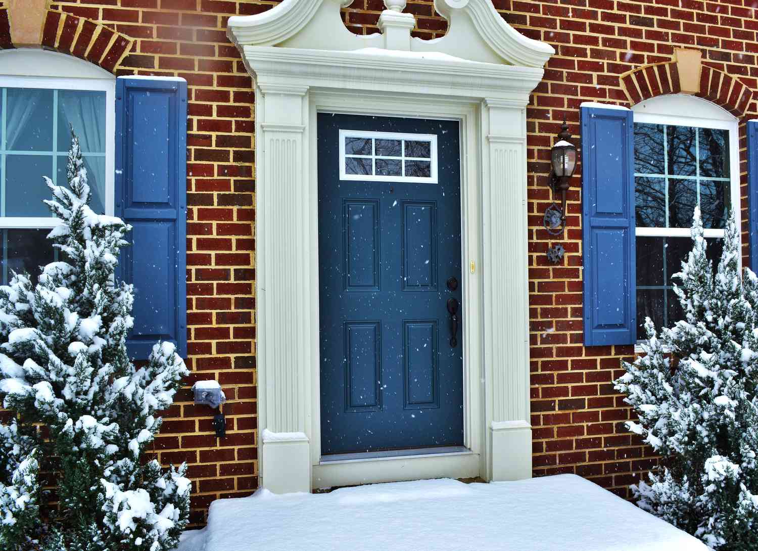 dark blue front door on brick house