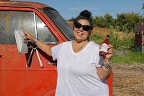 portrait of deb rock holding sonoma hot sauce bottle