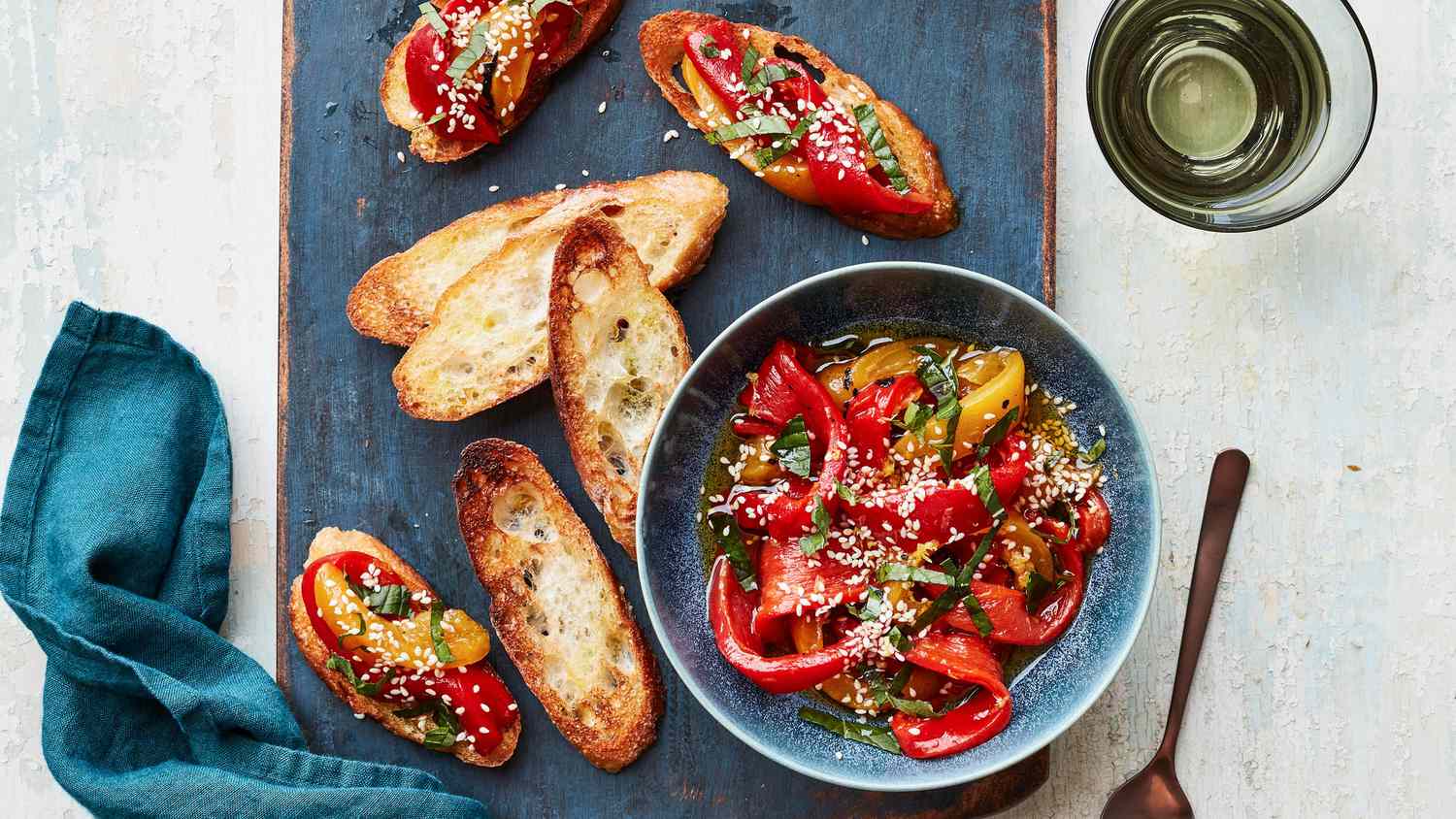 Marinated Peppers With Mint and Sesame on blue cutting board