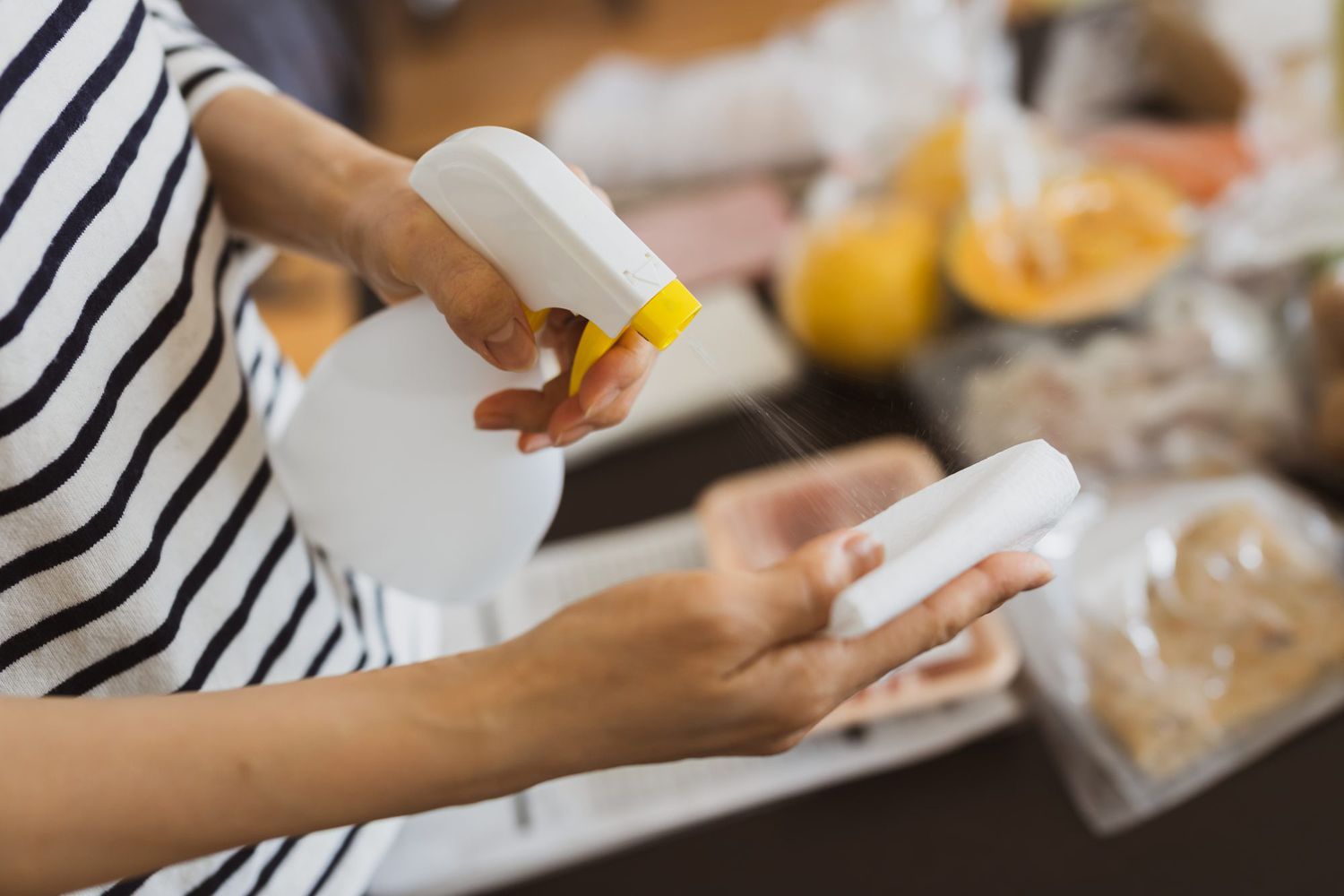 woman disinfecting groceries