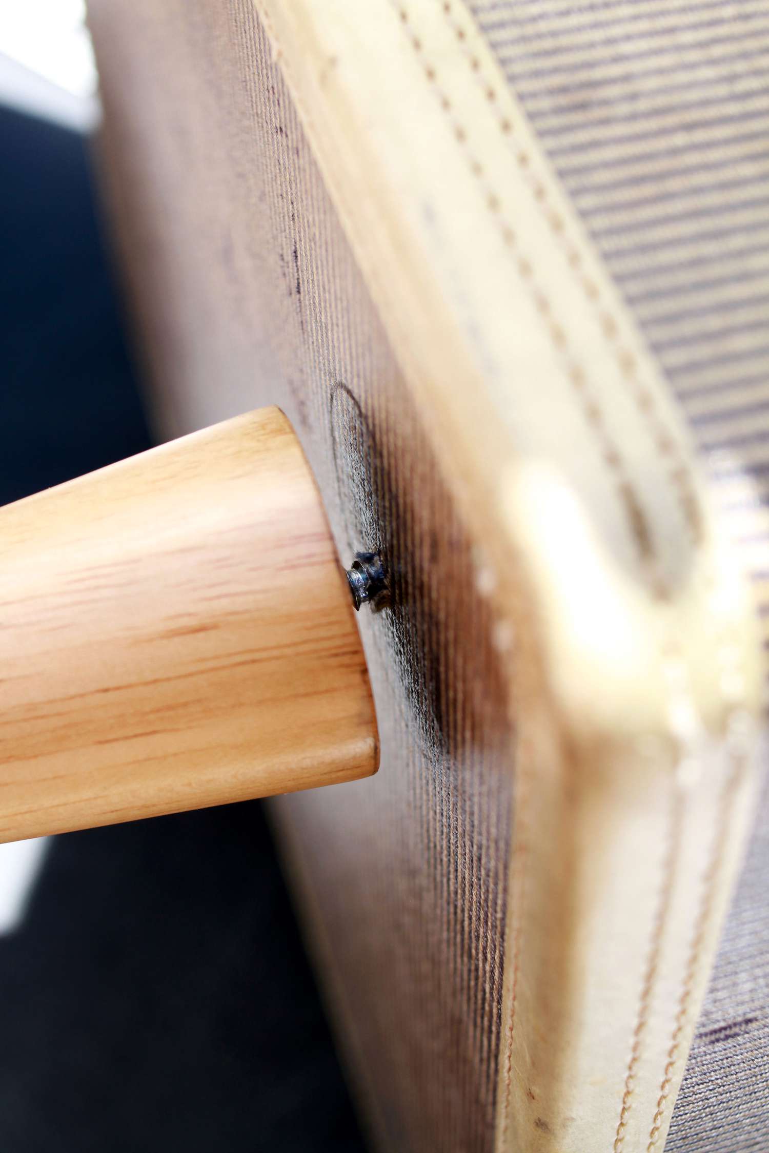 Screwing chair leg into suitcase