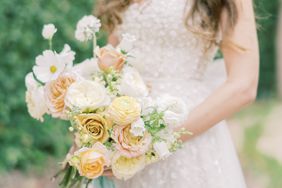 bride holding pastel citrus floral bouquet