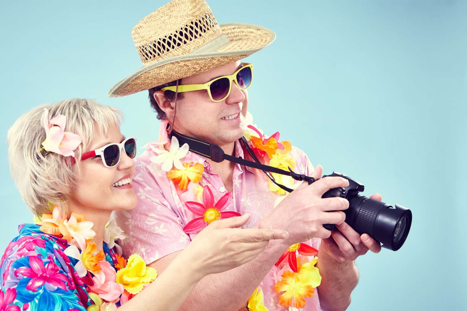 Tourist couple taking a picture with digital camera