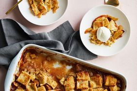 A freshly baked apple pandowdy in a baking dish with two servings plated one topped with ice cream