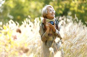 woman holding a camera in a field