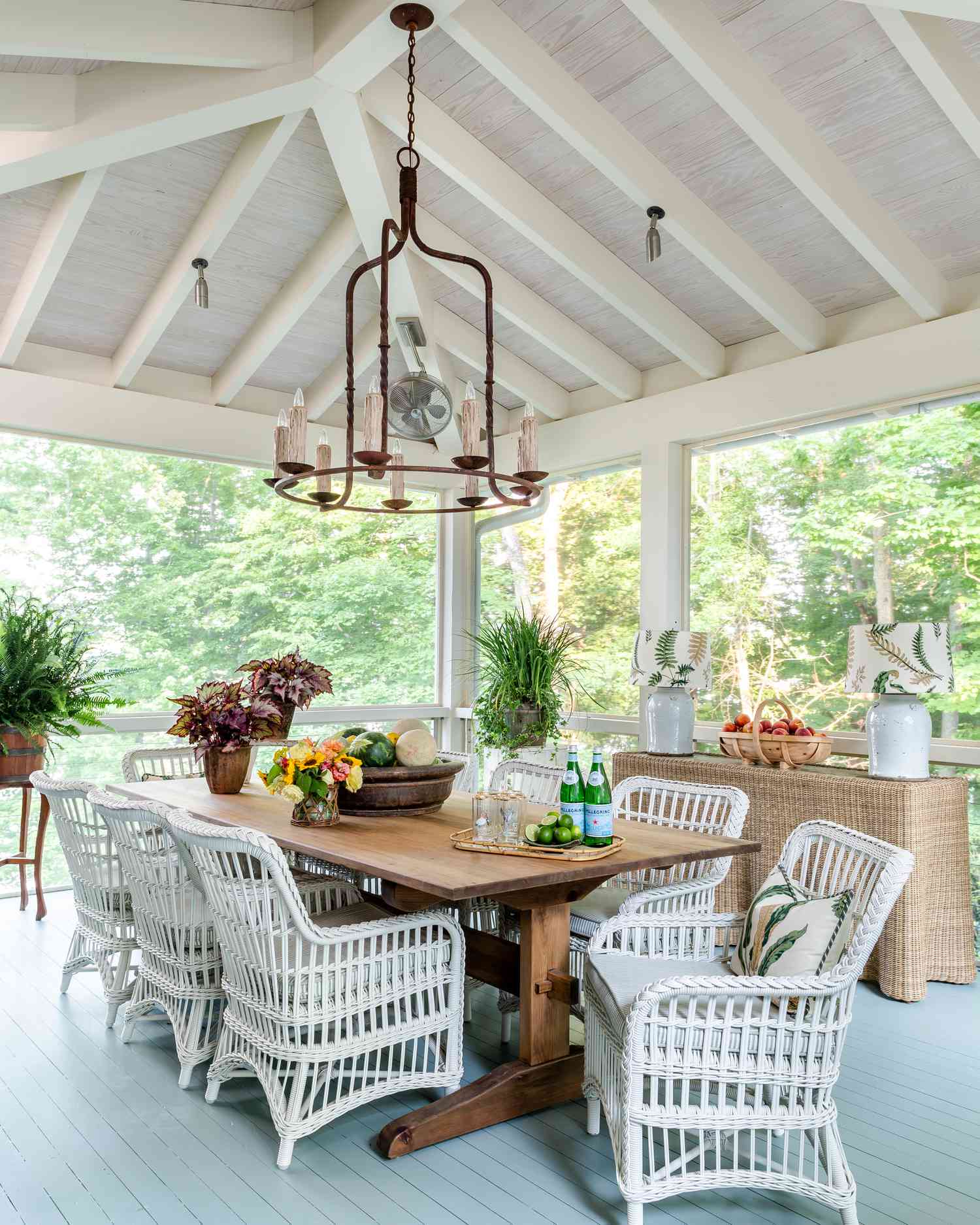 Enclosed porch with chandelier and wicker chairs