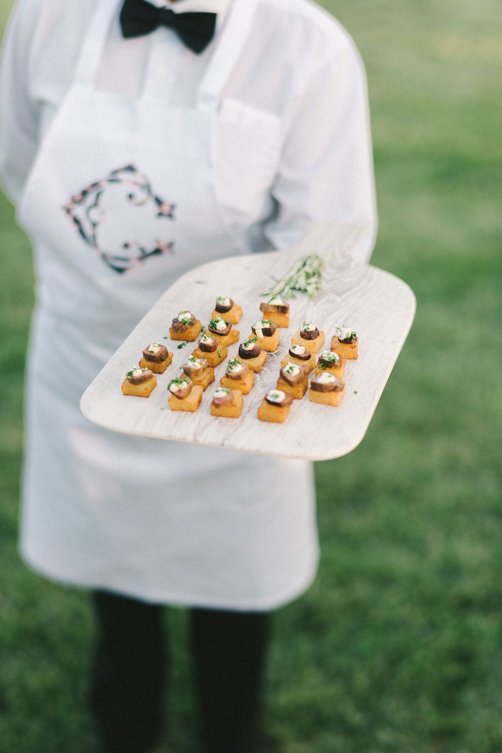 server holding tray of wedding food