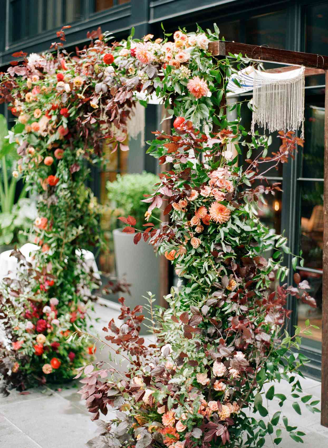 large floral and dark wood chuppah