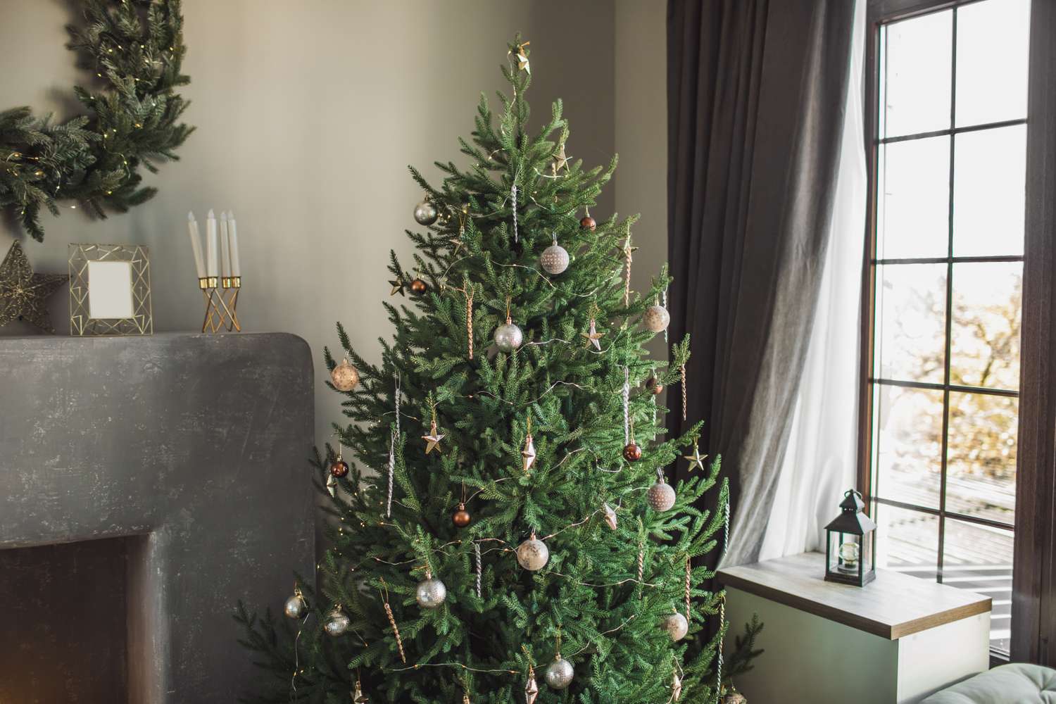 Decorated Christmas tree by a window in a cozy living room
