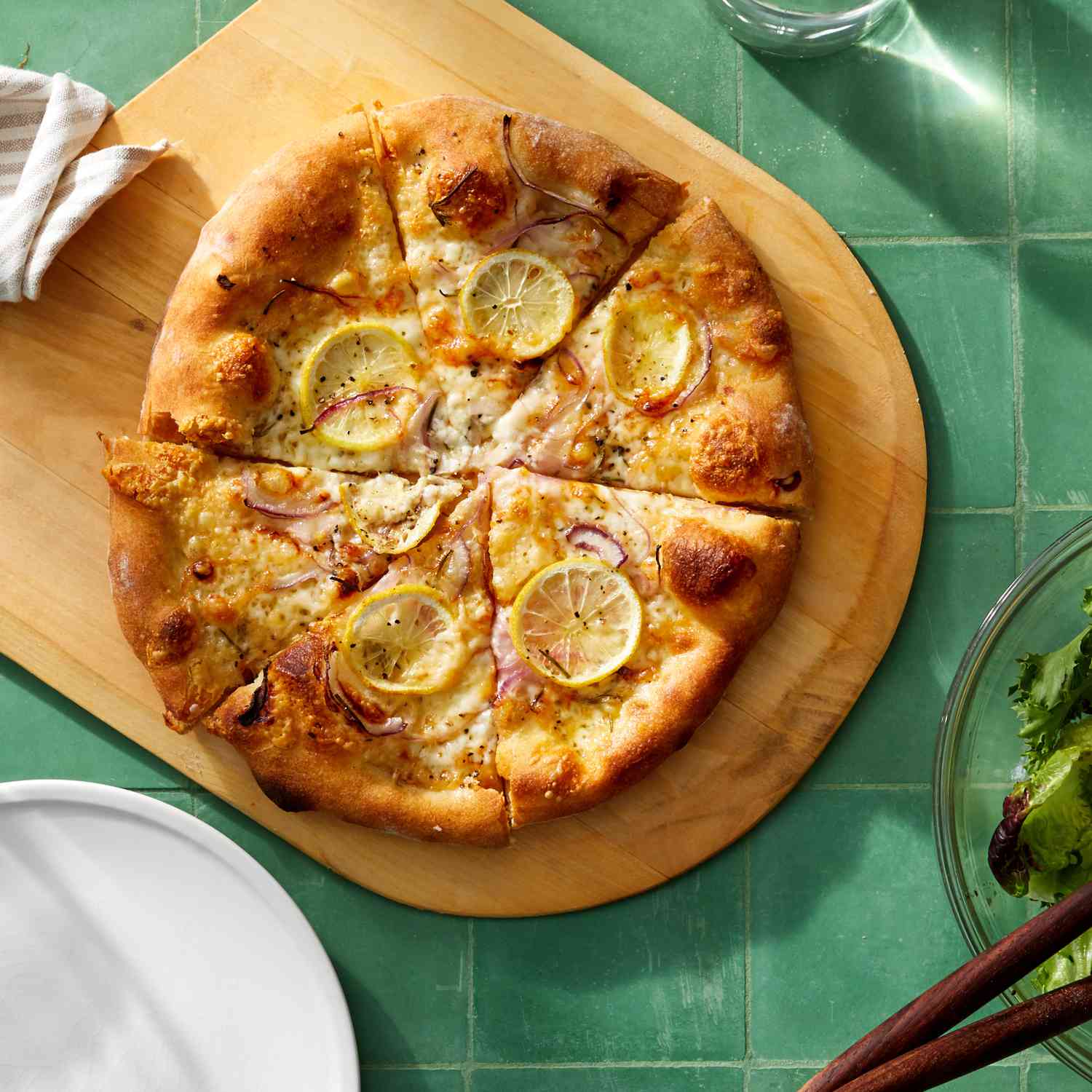 lemon cheese pizza on cutting board