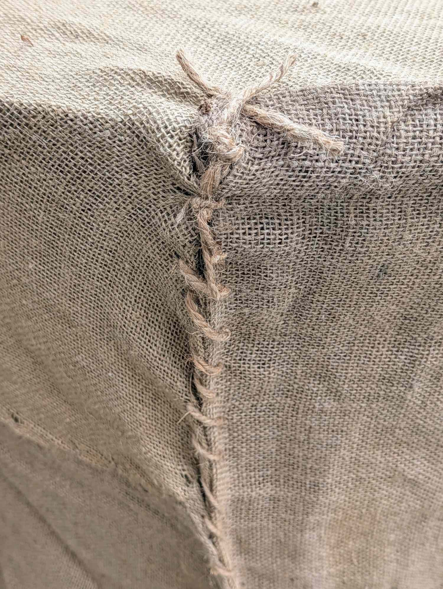 Closeup of a burlap fabric seam stitched with twine