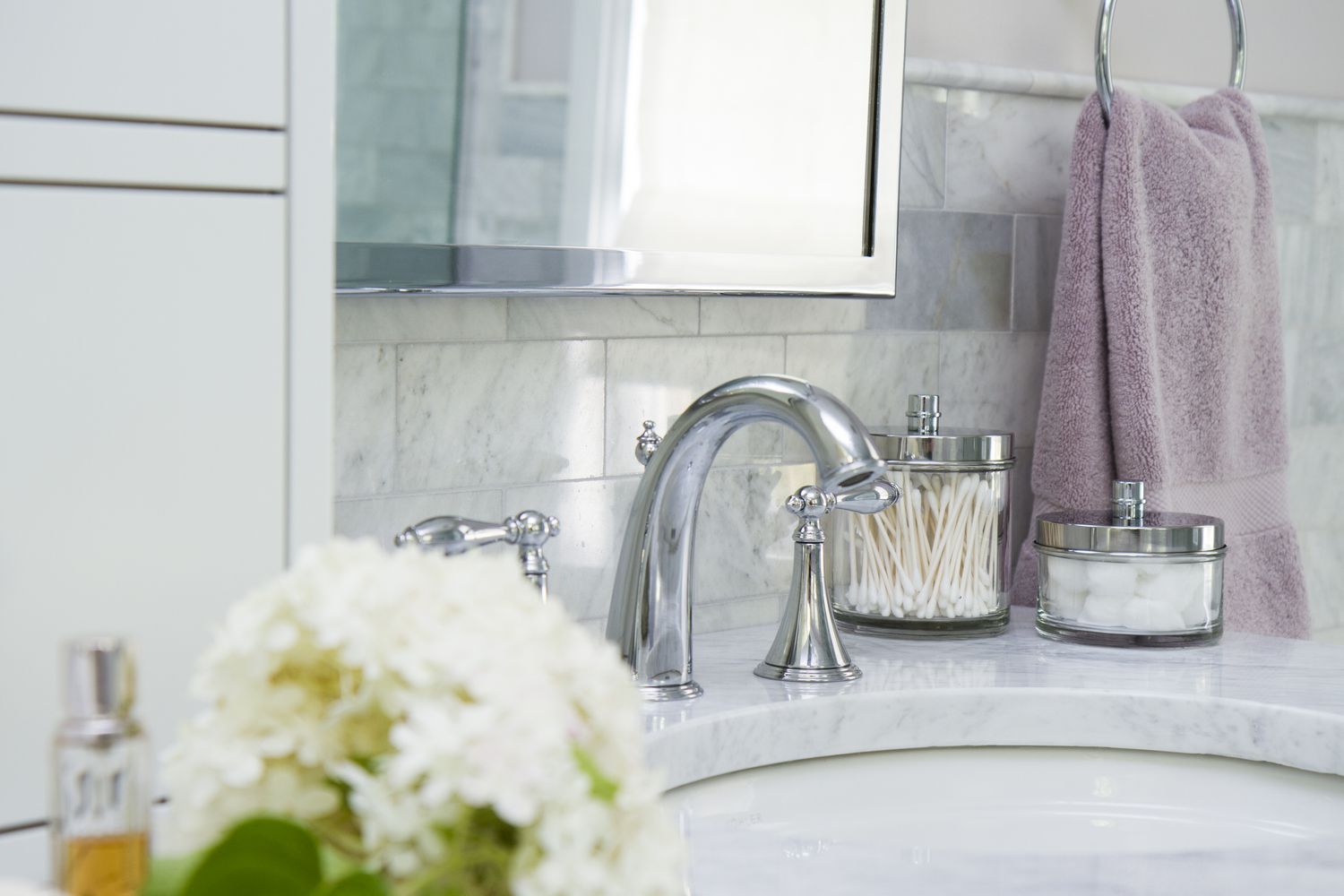 a sink with surrounding tile in a bathroom