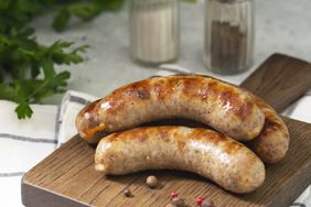 Grilled sausages on a wooden cutting board 