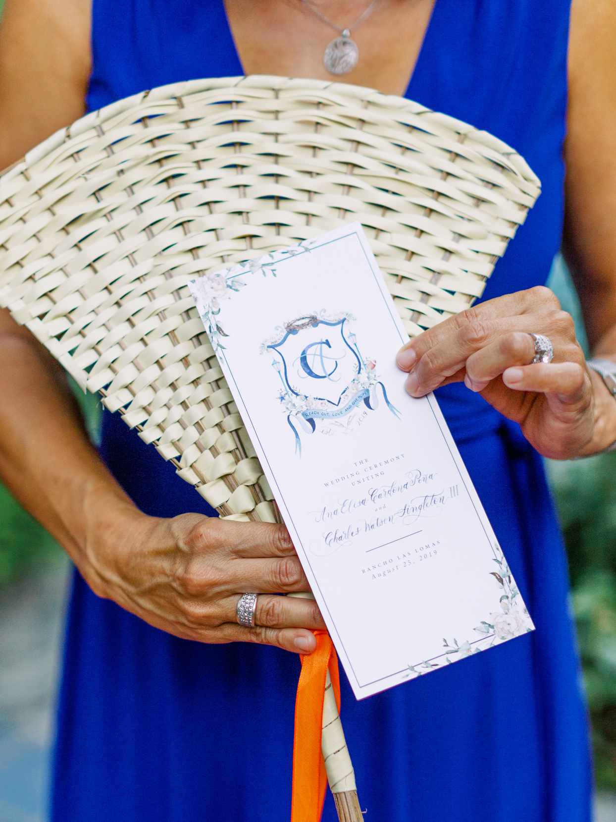 guest holding wedding ceremony fan