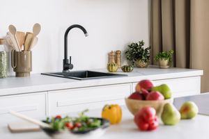 Fruit on counter near kitchen sink 