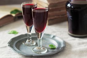 two cordial glasses with red liqueur