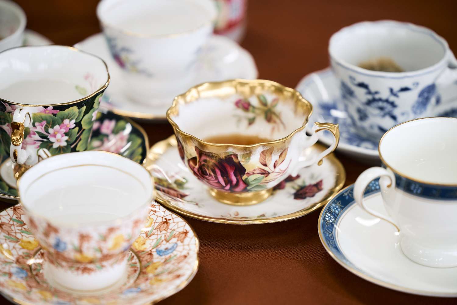 A collection of decorative teacups and saucers various floral and patterned designs