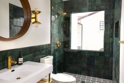 Walk in green tiled shower